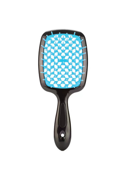 Cool tones edition: Ailsas brush with deep navy vents and black handle, gliding through thick curly hair without snags.