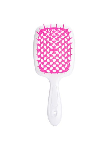 Modern duo-tone: Crisp white handle contrasts with vibrant fuchsia vents on this Ailsas brush, shown mid-stroke through wavy hair.