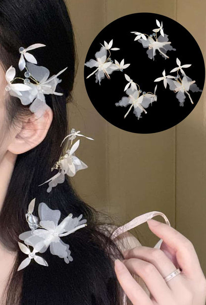 The clever Ailsa butterfly clip secures stray hair, while the perforated wings cast dappled shadows - a summer style must-have.