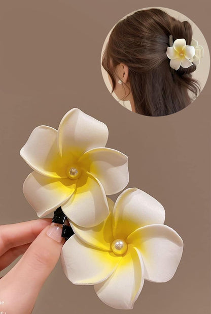 Tropical elegance: Ailsas frangipani hair clip brings vacation vibes to everyday styles, its UV-resistant petals maintaining color through beach days.