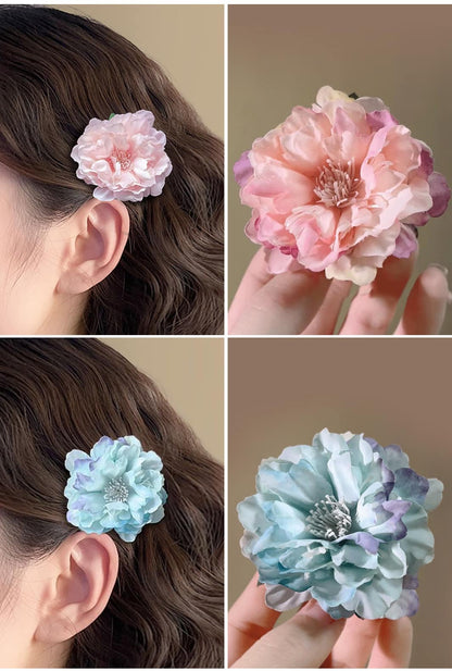 Ailsas ombre camellia clips in dusk purple-to-lilac gradients. The silicone-coated teeth securely hold wigs without snagging, perfect for photoshoots.