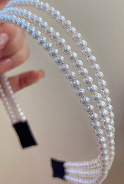 Inspired by French romanticism, the Salsas Pearl Headband features three alternating layers of pearls on a flexible wire frame, adding radiant elegance to updos and half-updos.