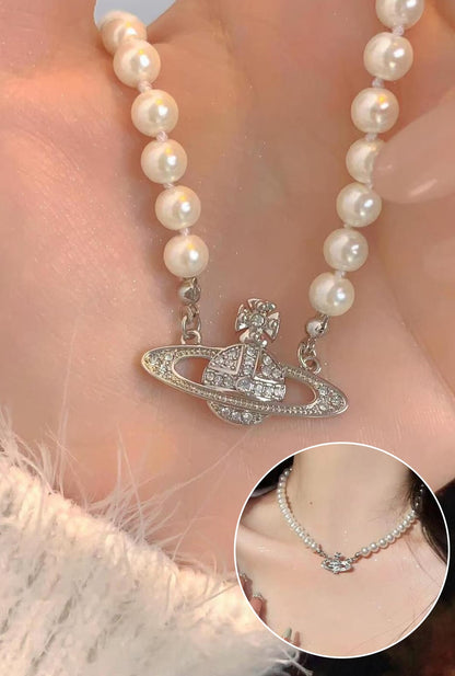 Ailsas punk planet necklace features spinning studded orbs and magnetic clasp for wig-friendly wear.