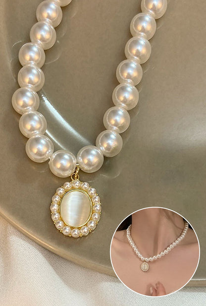 Ailsas subtle cat's eye pendant necklace features precision-cut stones that shift from olive to grey under light. 45cm cable chain with lobster clasp.