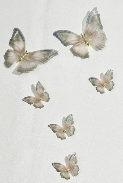 Enchanted garden: Ailsas botanical butterfly clip blends realistic petal textures with metallic accents for woodland fairy vibes.