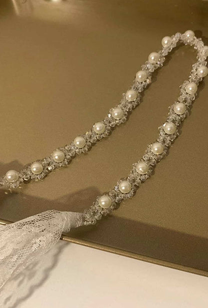 Ailsas tulle hair ribbon with Swarovski elements transforms between hair tie/band styles, scattering galaxy-like glimmers with movement.