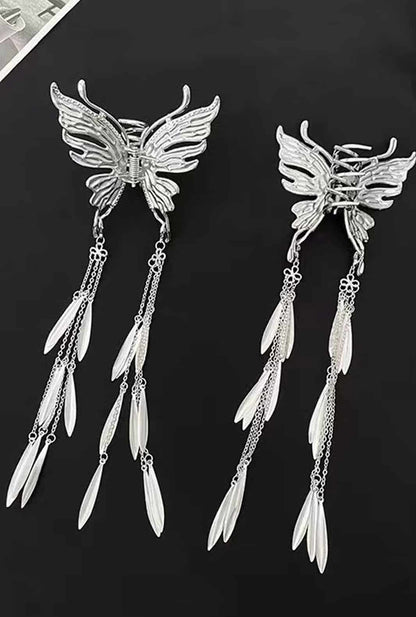 Ailsas 24cm butterfly claw clips with weighted alloy springs provide secure hold for thick hair. The 8cm wide design evenly distributes pressure while dangling tassels add movement.