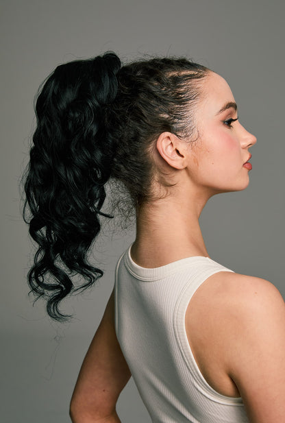 Back view of Hebbe black ponytail extension by Ailsa's Wigs, showing its voluminous long waves and neat wrap-around finish.