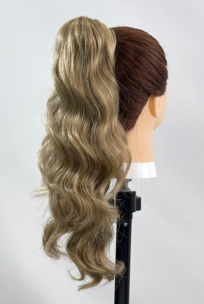 Lynn by Ailsa’s Wigs, captured from the right-back angle to highlight the light ash blonde waves, airy texture, and natural wrap-around ponytail extension fit.