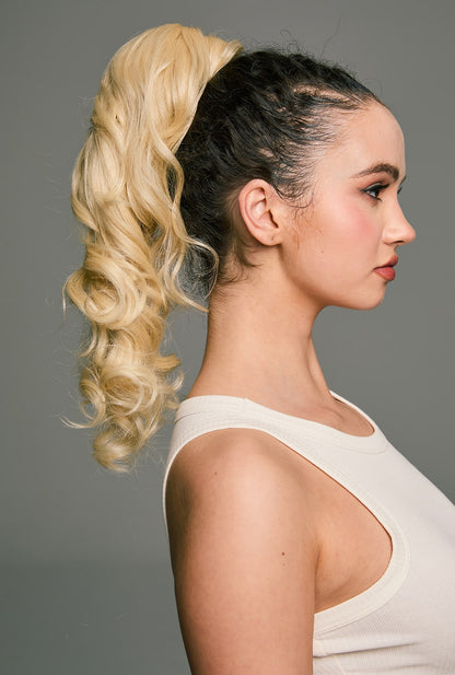 Melody by Ailsa's Wigs – Soft flowing blonde waves captured from back-right, highlighting layered texture and ready-styled ponytail shape.