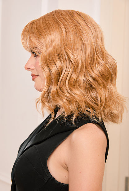 Dynamic left side movement of Sandy curly wig by Ailsa's Wigs showing lively bounce with every step