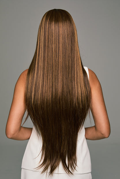 Back view of Lucy long straight wig - 32-inch smooth strands with honey blonde highlights flowing elegantly