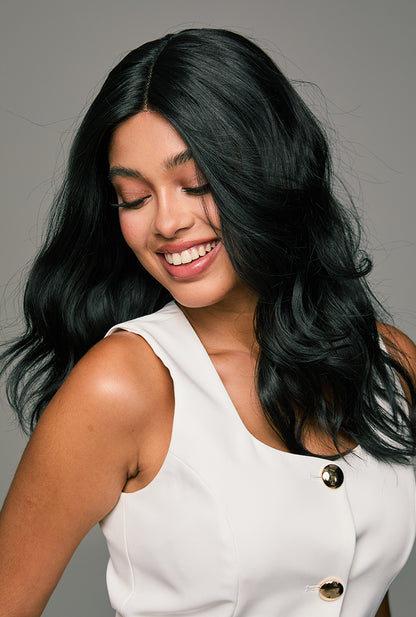 Confident wearer showcase of Maya wig by Ailsa's Wigs with radiant smile and elegant curls