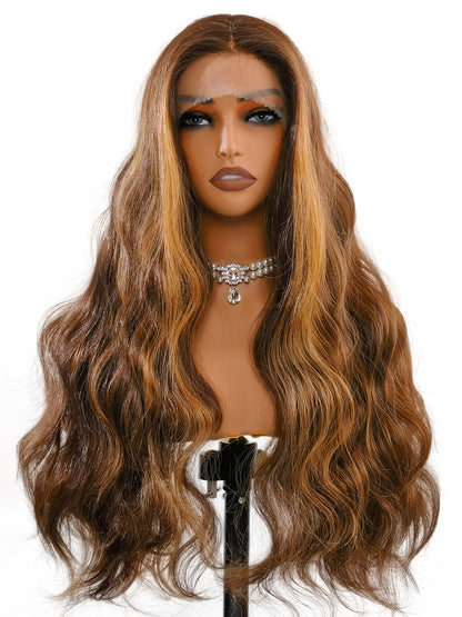 Frontal elegance of Natalia wig by Ailsa's Wigs demonstrates how the body waves naturally frame the face, with soft highlights adding warmth and dimension to all skin tones.