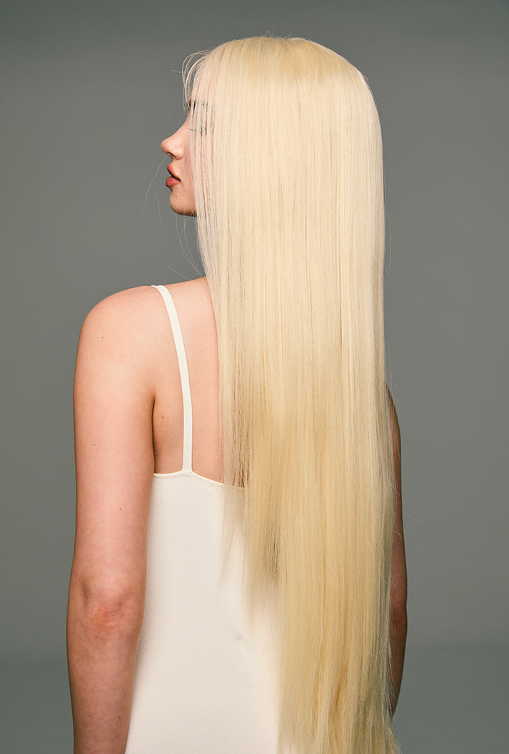 Side-back view of Leah by Ailsa's Wigs, featuring platinum and light gold blonde tones in a 32-inch silky straight design, evoking golden silk brilliance.