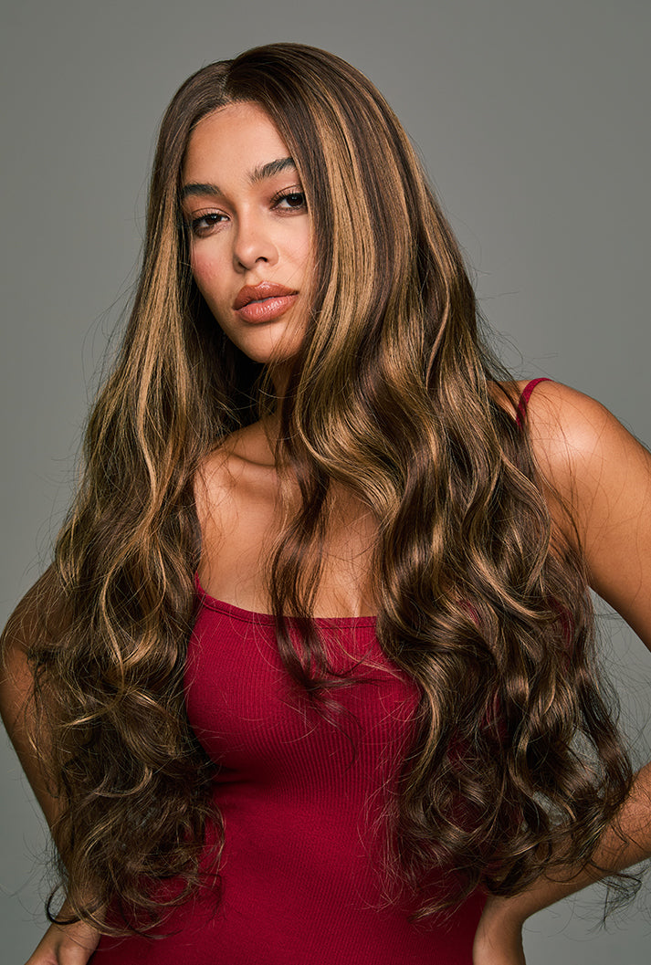 The Willow 28-inch loose wave lace front wig by Ailsa's Wigs, displayed from the left front view. The body wave curls bounce with every movement, offering a natural and lively texture with a touch of effortless glamour.