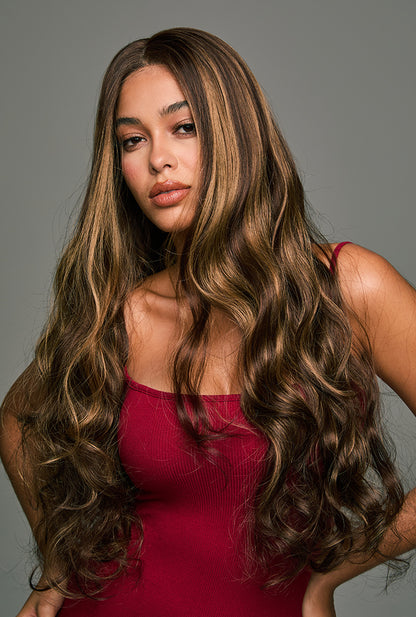 The Willow 28-inch loose wave lace front wig by Ailsa's Wigs, displayed from the left front view. The body wave curls bounce with every movement, offering a natural and lively texture with a touch of effortless glamour.