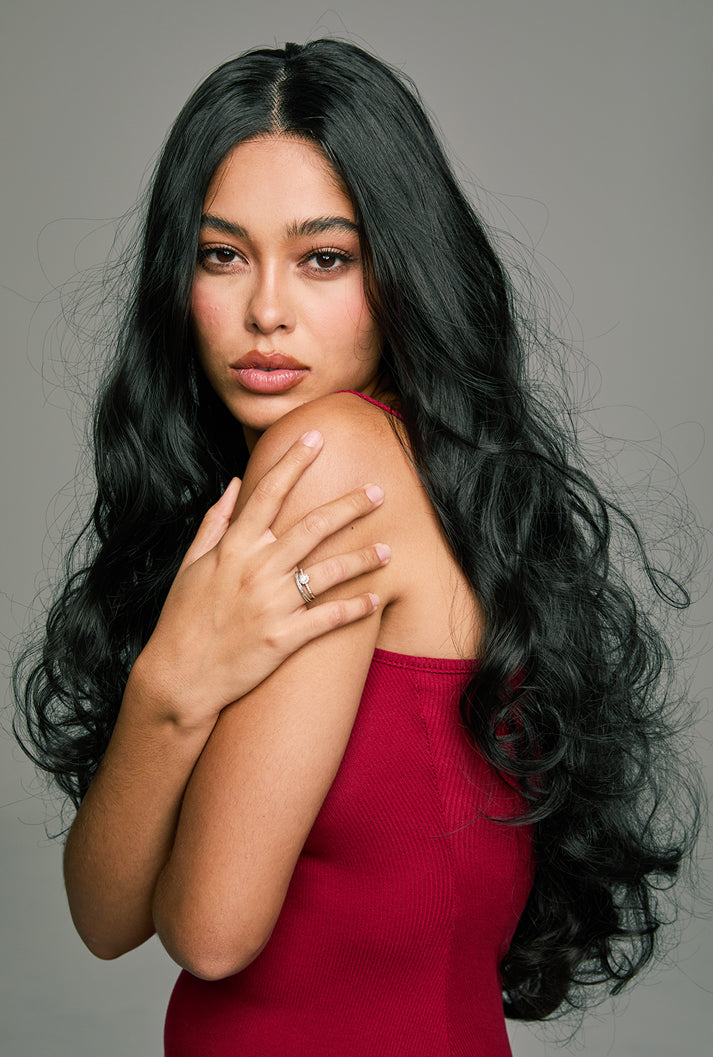 Piper 32-inch natural black loose wave hair wig by Ailsa's Wigs, left front view. Natural flowing waves evoke graceful movement, perfect for effortless glamour.